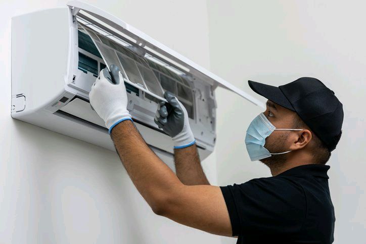 AC technician servicing air conditioner in Dubai